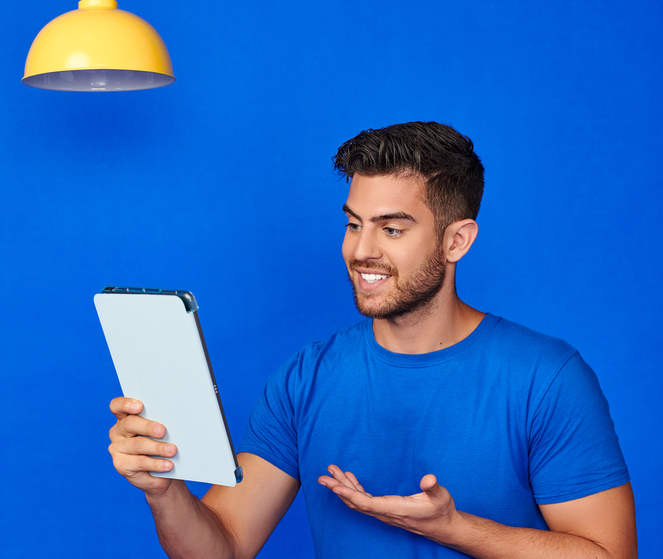 A man holding a tablet computer, focused on the screen.