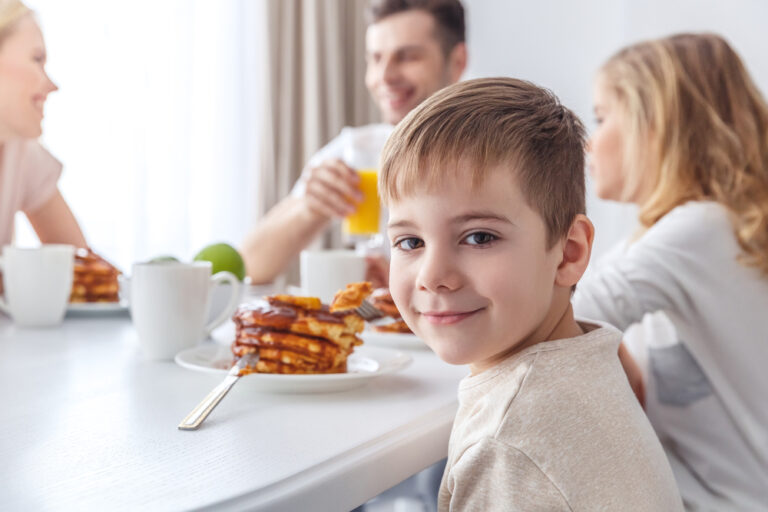 This image shows a happy family eating together