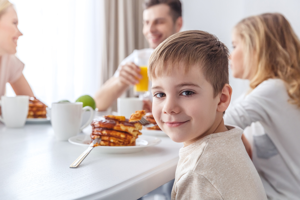 This image shows a happy family eating together